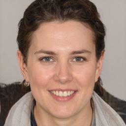 Joyful white young-adult female with medium  brown hair and blue eyes