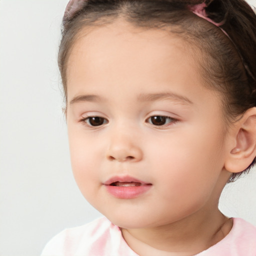 Joyful white child female with short  brown hair and brown eyes