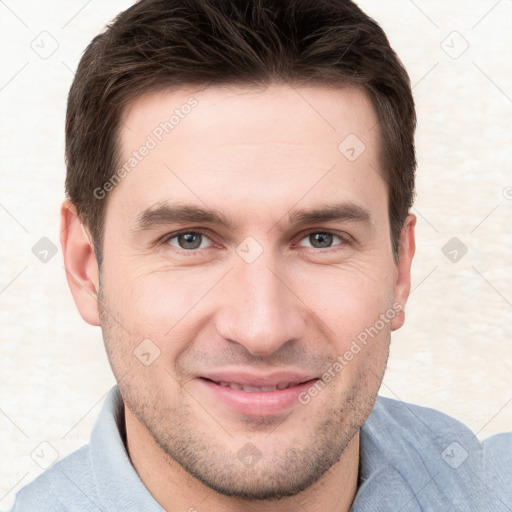 Joyful white young-adult male with short  brown hair and grey eyes