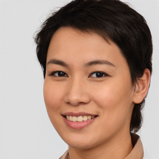 Joyful asian young-adult female with medium  brown hair and brown eyes
