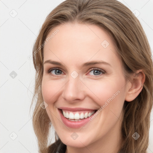 Joyful white young-adult female with long  brown hair and grey eyes