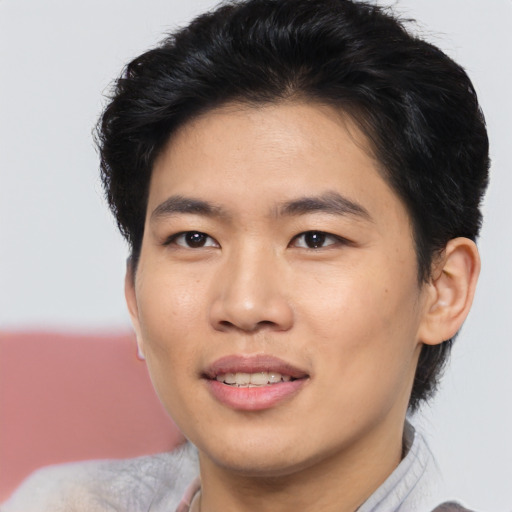 Joyful asian young-adult male with short  brown hair and brown eyes