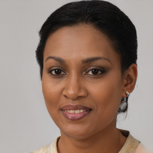 Joyful black young-adult female with short  brown hair and brown eyes