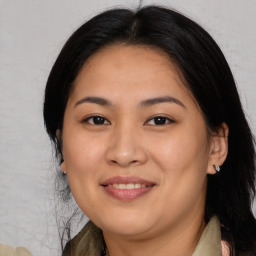 Joyful asian young-adult female with long  brown hair and brown eyes