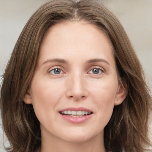 Joyful white young-adult female with long  brown hair and grey eyes