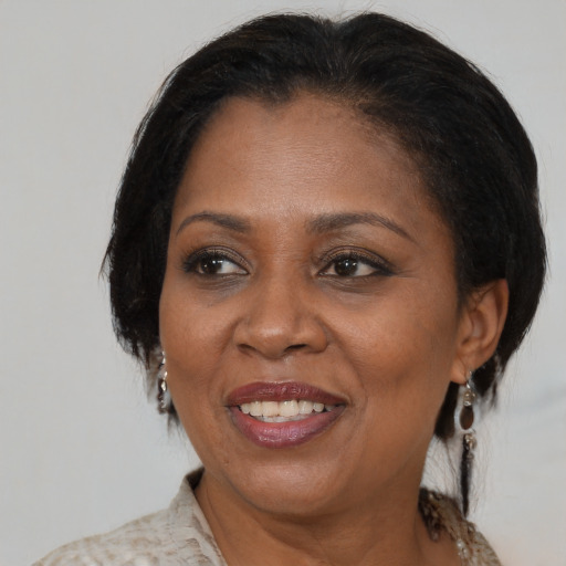 Joyful black adult female with medium  brown hair and brown eyes