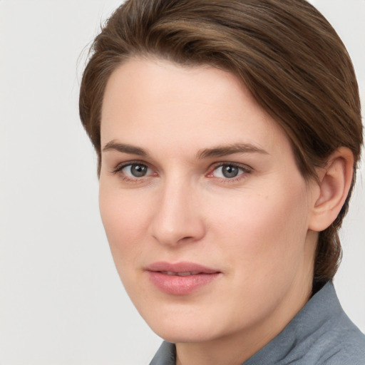 Joyful white young-adult female with short  brown hair and grey eyes