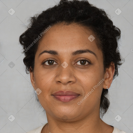 Joyful black adult female with short  brown hair and brown eyes