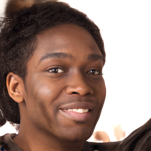 Joyful black young-adult male with short  brown hair and brown eyes