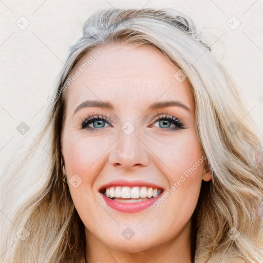 Joyful white young-adult female with long  brown hair and blue eyes