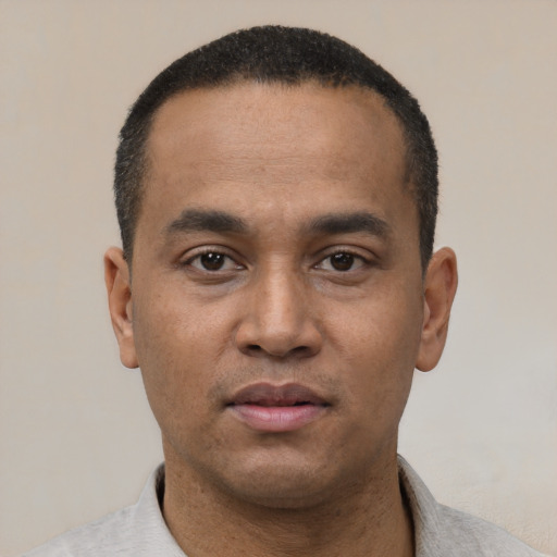 Neutral latino young-adult male with short  black hair and brown eyes