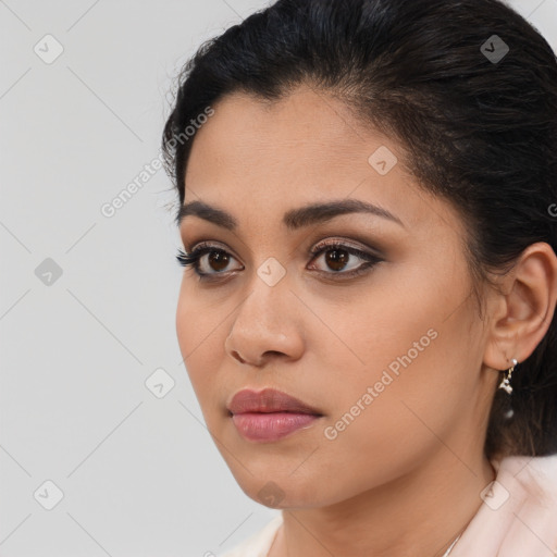 Joyful latino young-adult female with medium  brown hair and brown eyes