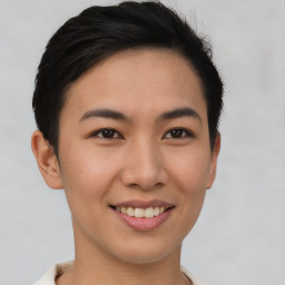 Joyful asian young-adult female with short  brown hair and brown eyes