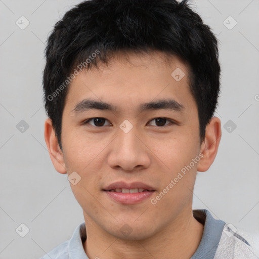 Joyful asian young-adult male with short  black hair and brown eyes