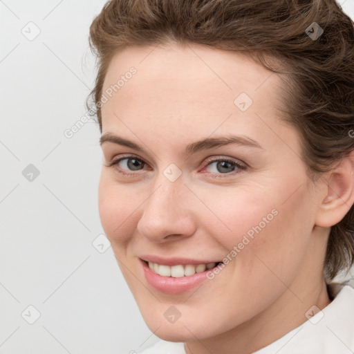 Joyful white young-adult female with medium  brown hair and blue eyes