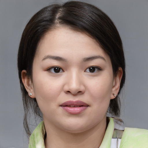 Joyful asian young-adult female with medium  brown hair and brown eyes