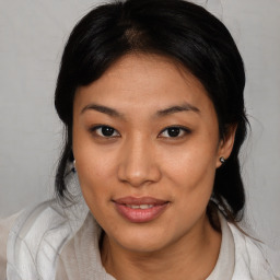 Joyful asian young-adult female with medium  brown hair and brown eyes