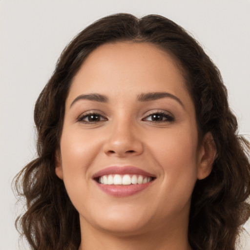 Joyful white young-adult female with long  brown hair and brown eyes