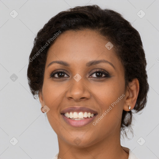 Joyful black young-adult female with medium  brown hair and brown eyes