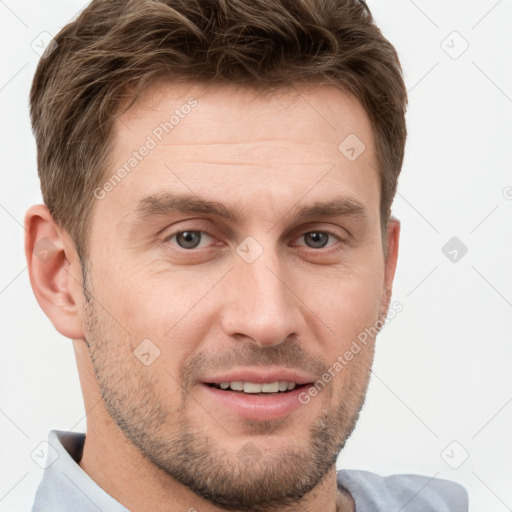 Joyful white young-adult male with short  brown hair and grey eyes