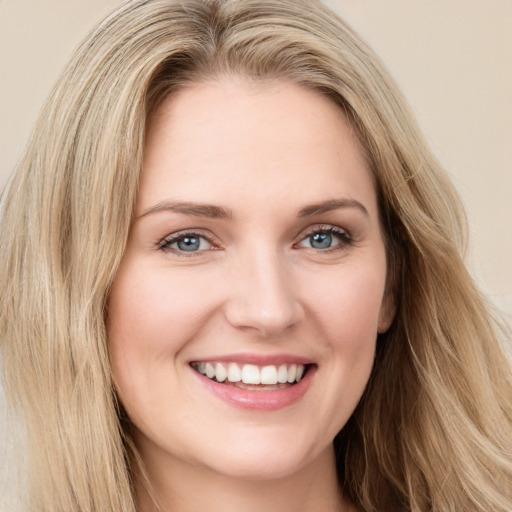 Joyful white young-adult female with long  brown hair and green eyes