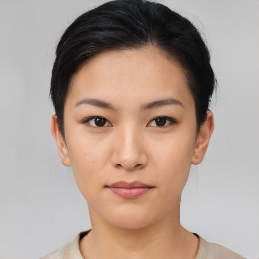 Joyful asian young-adult female with short  black hair and brown eyes