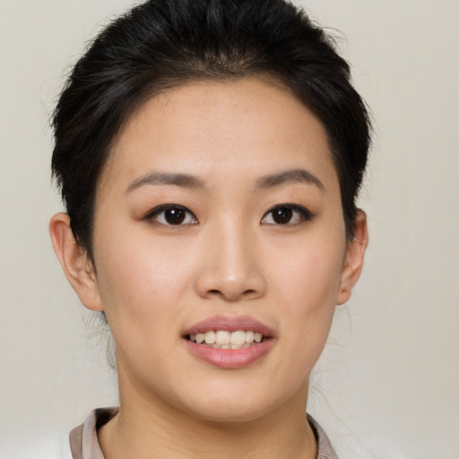 Joyful asian young-adult female with short  brown hair and brown eyes