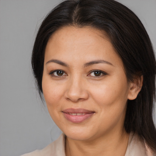 Joyful asian adult female with medium  brown hair and brown eyes