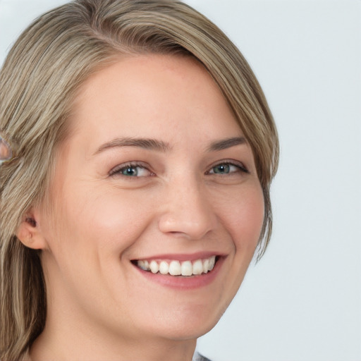 Joyful white young-adult female with long  brown hair and blue eyes