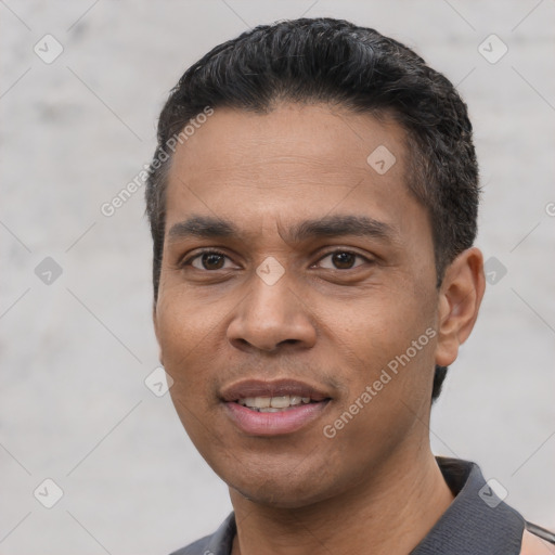 Joyful white young-adult male with short  black hair and brown eyes