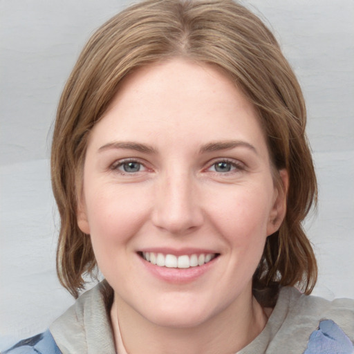 Joyful white young-adult female with medium  brown hair and blue eyes