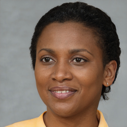 Joyful black young-adult female with short  brown hair and brown eyes