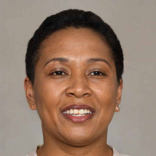 Joyful latino adult female with short  brown hair and brown eyes