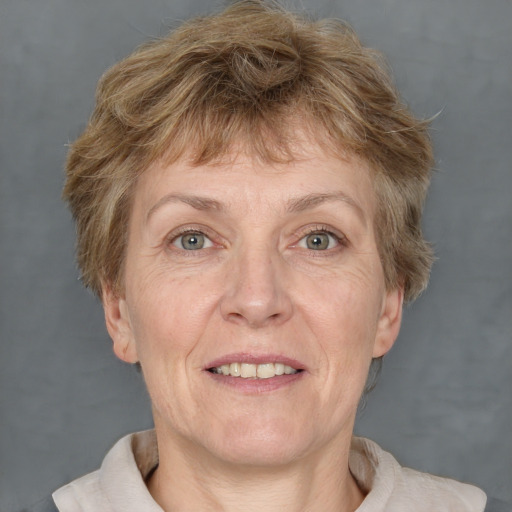 Joyful white middle-aged female with short  brown hair and grey eyes