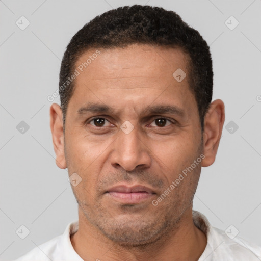 Neutral latino adult male with short  brown hair and brown eyes