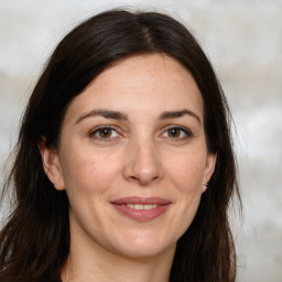 Joyful white adult female with long  brown hair and brown eyes