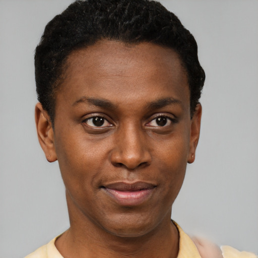 Joyful black young-adult female with short  black hair and brown eyes