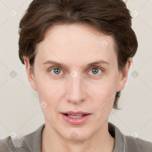 Joyful white young-adult female with short  brown hair and grey eyes