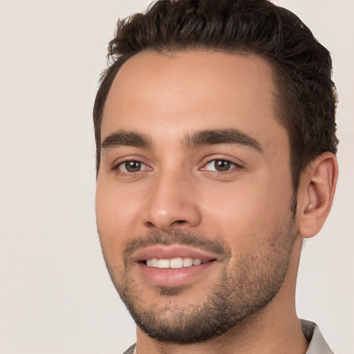 Joyful white young-adult male with short  brown hair and brown eyes