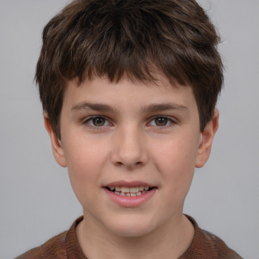 Joyful white child male with short  brown hair and grey eyes