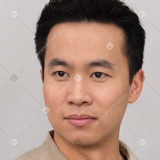 Joyful asian young-adult male with short  black hair and brown eyes