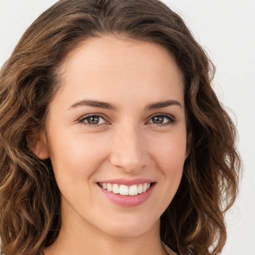 Joyful white young-adult female with long  brown hair and green eyes