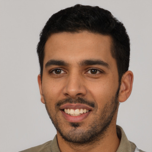 Joyful latino young-adult male with short  black hair and brown eyes