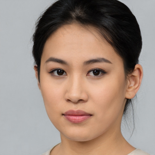 Joyful asian young-adult female with medium  brown hair and brown eyes