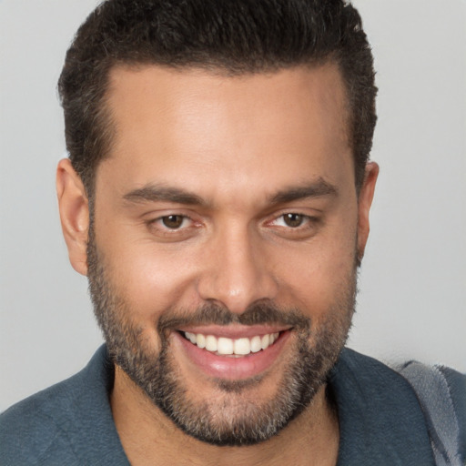 Joyful white young-adult male with short  brown hair and brown eyes