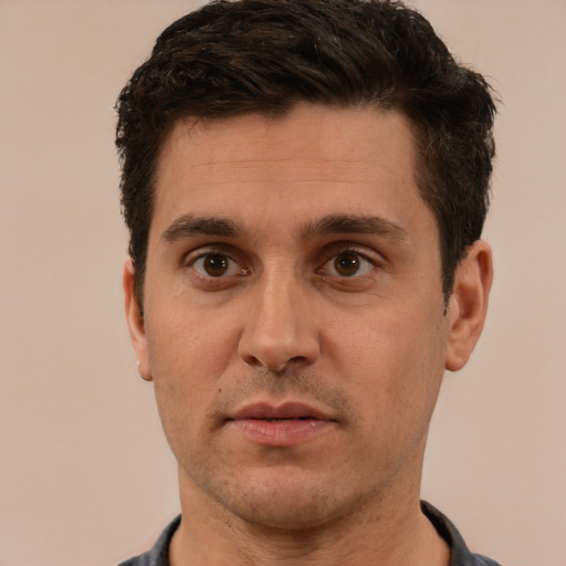 Joyful white adult male with short  brown hair and brown eyes