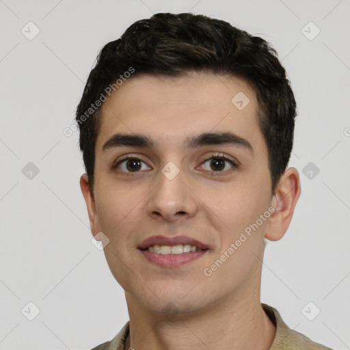 Joyful white young-adult male with short  black hair and brown eyes