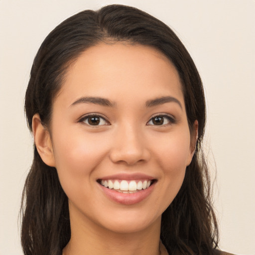 Joyful white young-adult female with long  brown hair and brown eyes