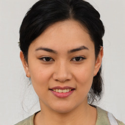 Joyful asian young-adult female with medium  black hair and brown eyes