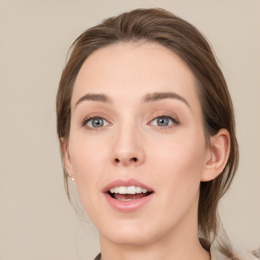 Joyful white young-adult female with medium  brown hair and green eyes